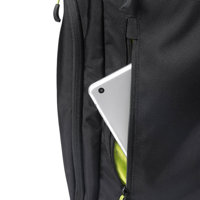 A sleek black backpack features a tablet partially visible in a zipped compartment, accented by vibrant green interior.