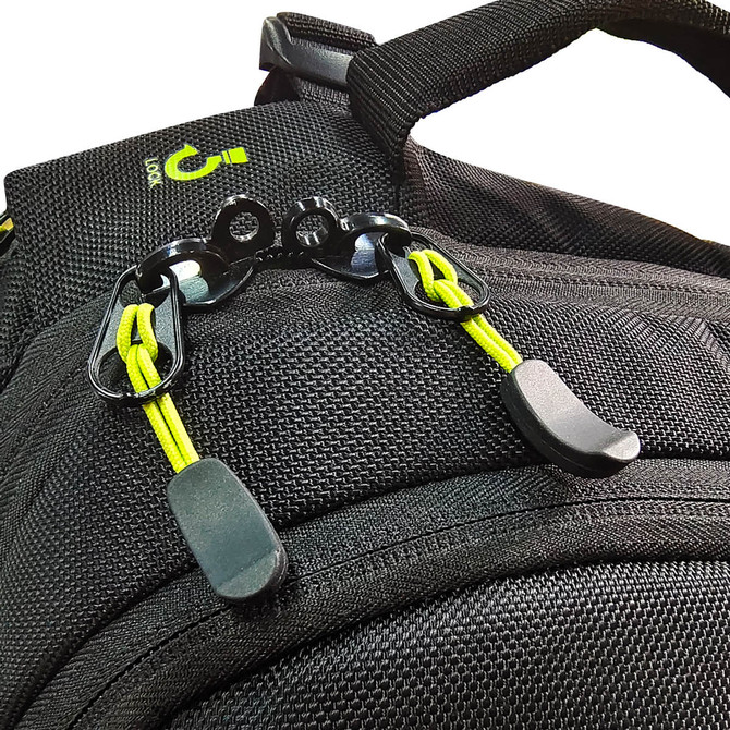 A close-up of black fabric with yellow accents, featuring clips and adjustable straps on a backpack.