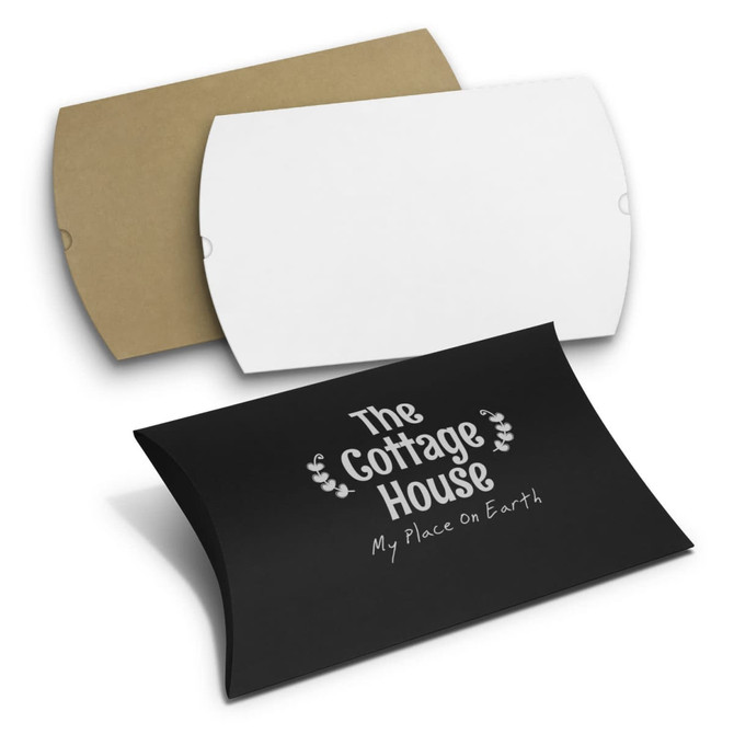 Three pillow boxes in black, white, and brown. The black box features a logo or branding.