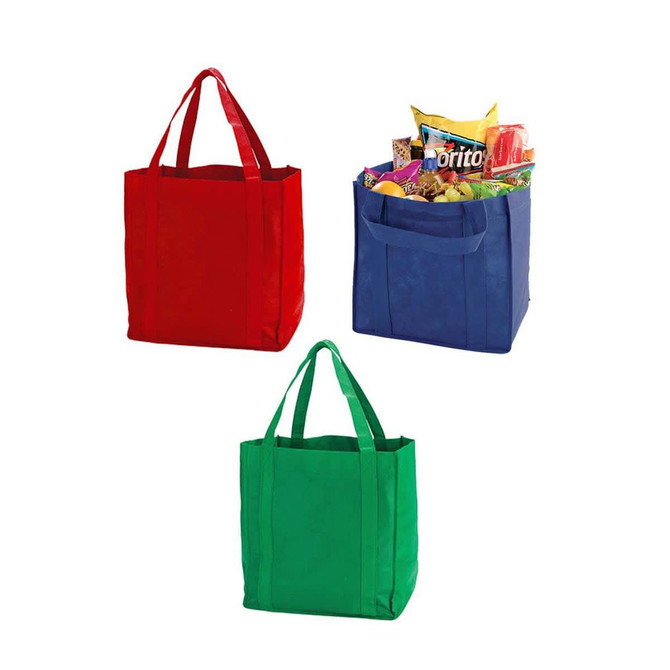 Three non-woven shopping totes in red, blue, and green, one filled with snacks. Each bag has double handles and a logo.