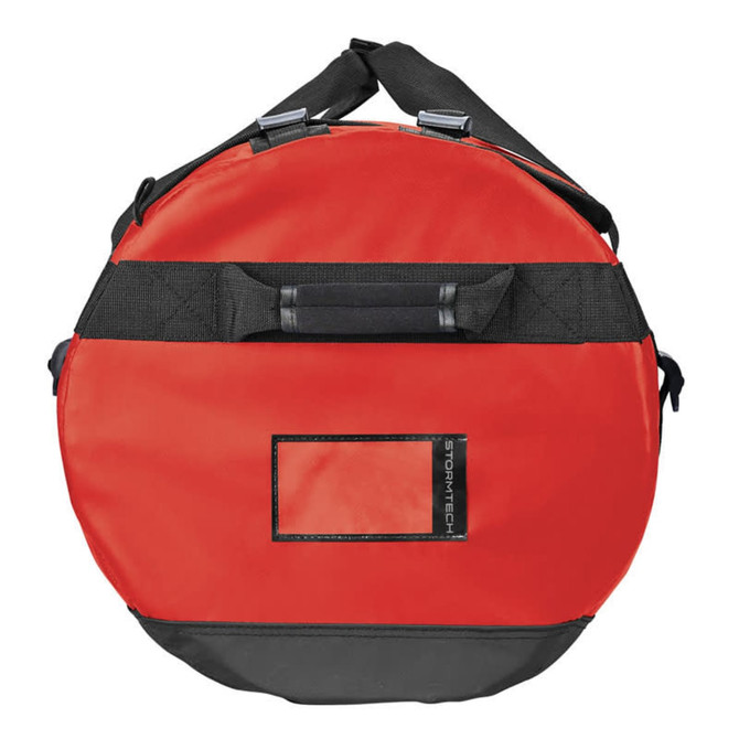 A round, medium waterproof gear bag in red and black, featuring adjustable straps and a logo.
