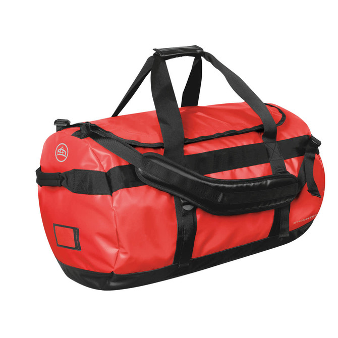 A medium red waterproof gear bag with black accents and multiple carrying straps. It features a logo.