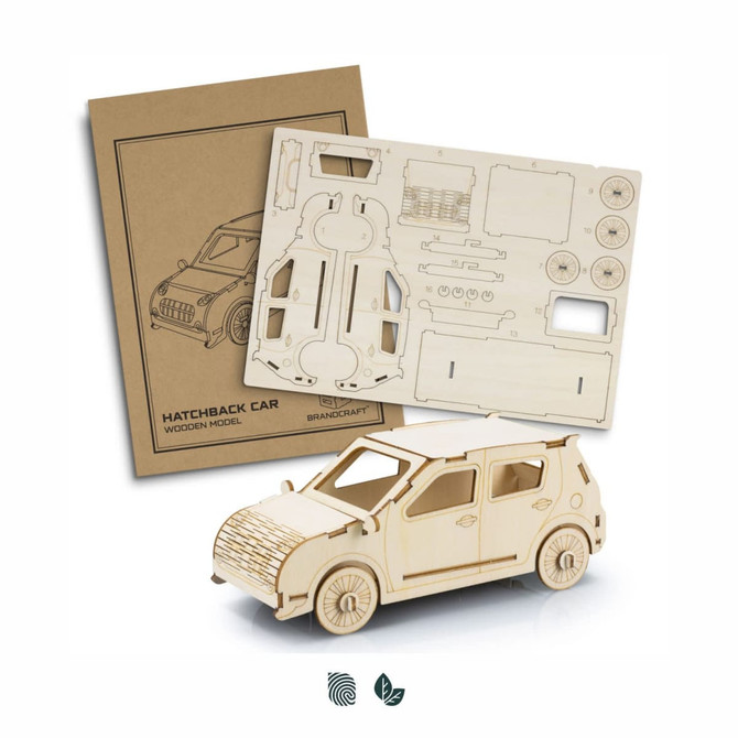 A wooden model of a hatchback car in natural colour, accompanied by an unassembled cardboard sheet with parts and details.