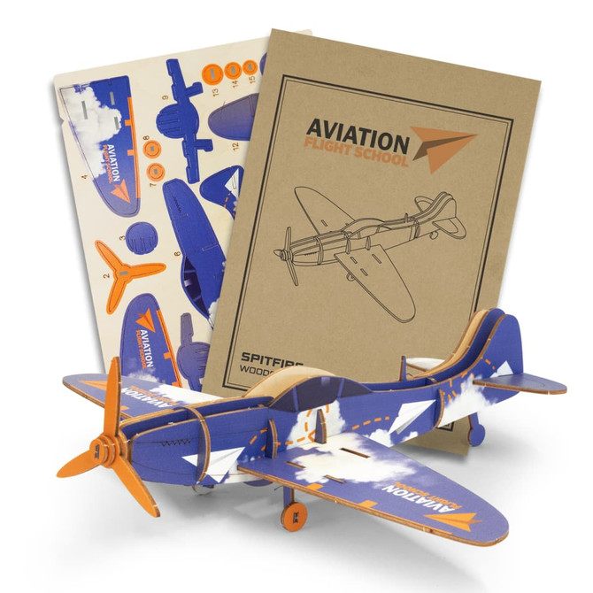 A wooden model aeroplane in blue, orange, and white, accompanied by assembly instructions and printed materials.
