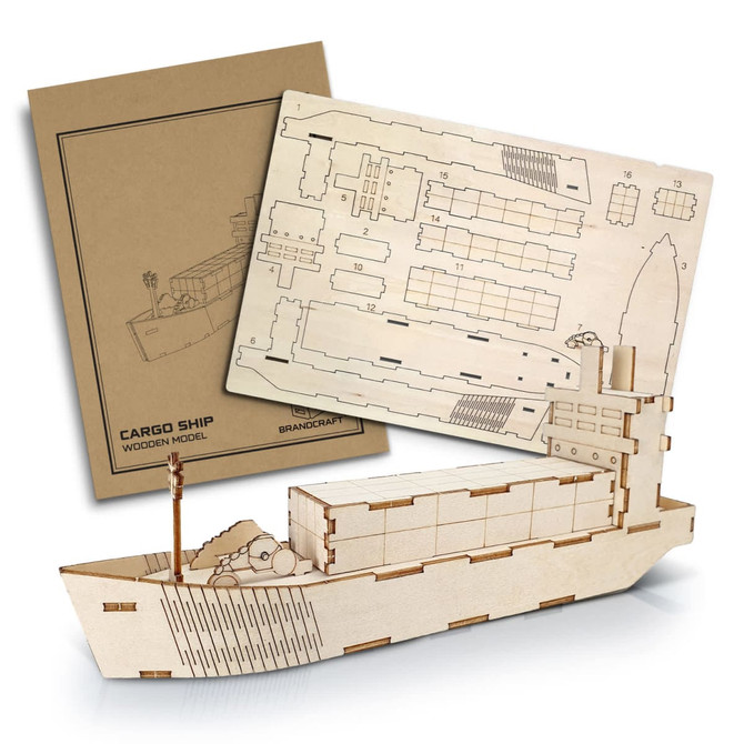 A wooden model of a cargo ship in natural timber, accompanied by a detailed assembly diagram. Includes packaging.