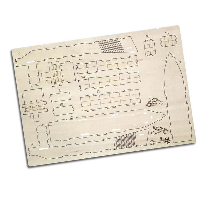 A wooden model kit of a cargo ship, featuring various detailed cut-out parts on a light-coloured base.