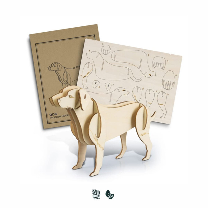 A wooden dog model in natural wood colour, with a template sheet and assembly instructions behind it.