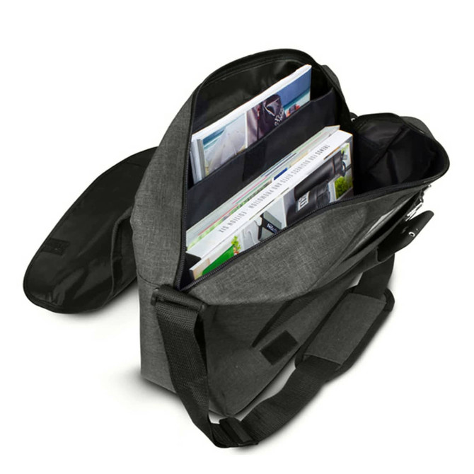 A grey messenger bag with an open flap, revealing magazines and organisational pockets inside. It has a logo.