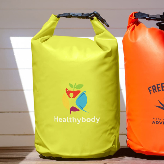 A yellow dry bag with a logo, featuring a roll-top closure and a sturdy handle.
