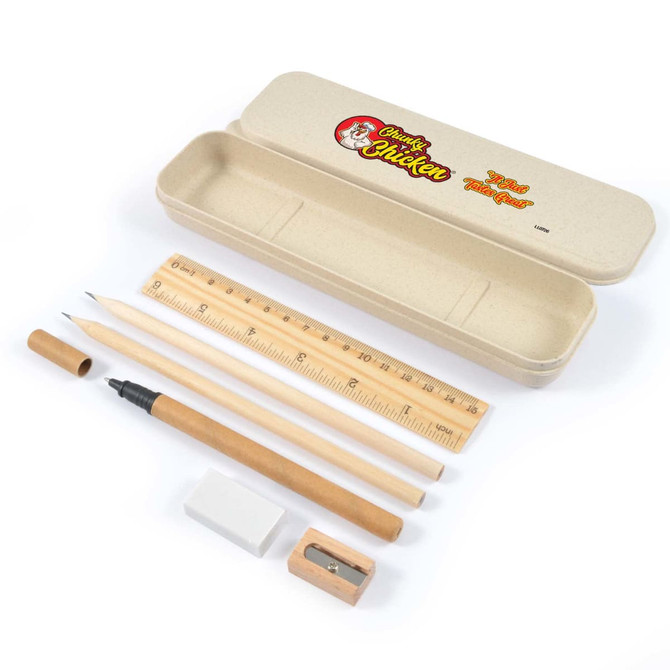 A stationery set in a beige case, featuring a pencil, pen, ruler, eraser, and sharpener, with a logo on the case.