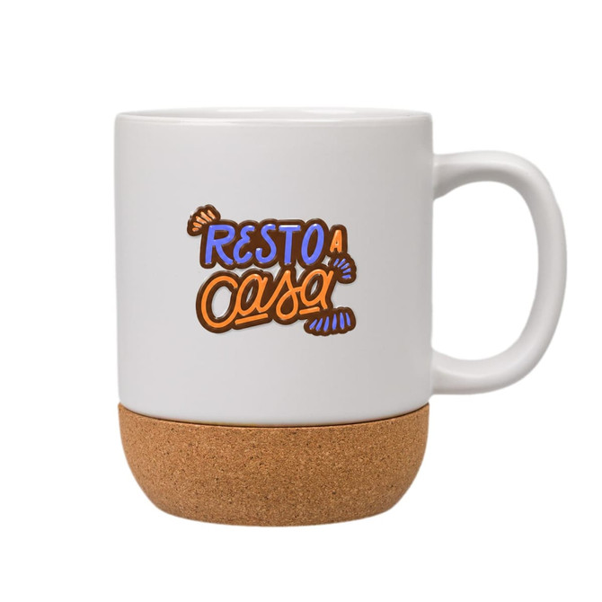 A ceramic mug with a cork base, featuring colourful text and a logo on a white background.