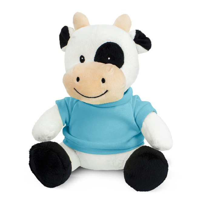 A cow plush toy with a black and white body, wearing a blue top, sitting on a white background.