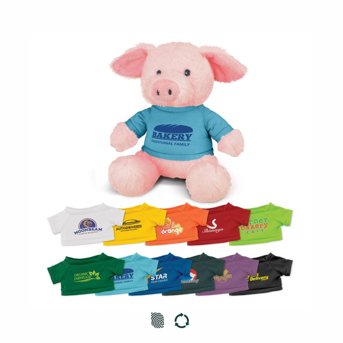 A pink pig plush toy wearing a blue shirt with a logo, surrounded by various coloured t-shirts.