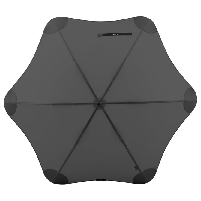 A black BLUNT Classic Umbrella viewed from above, featuring a unique star shape and a central hub.