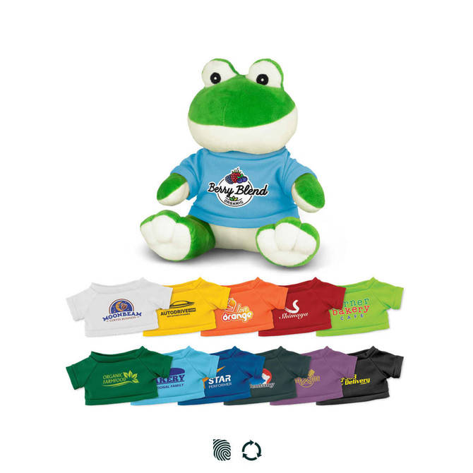 A green frog plush toy wearing a blue shirt, surrounded by various T-shirts in different colours and designs.