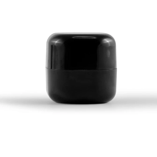 A black cube-shaped lip balm container with a glossy finish. It features a minimalist design and has a logo.