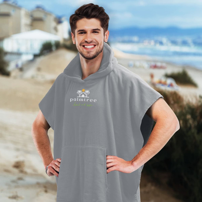A grey hooded towel featuring a front pocket and a logo, designed for personal use.