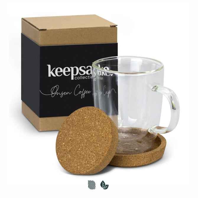 A glass coffee mug with a handle, accompanied by a cork coaster, in a box featuring a logo.