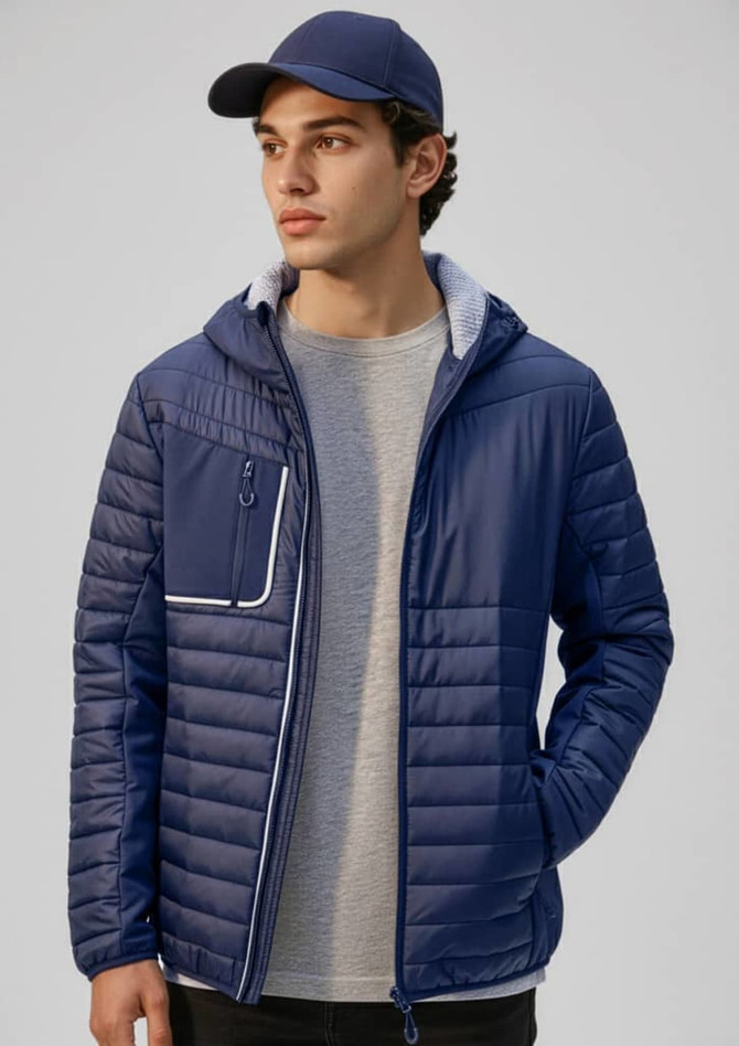 A unisex navy soft shell jacket with a hood, featuring a zip pocket and a lined interior, worn by a model.