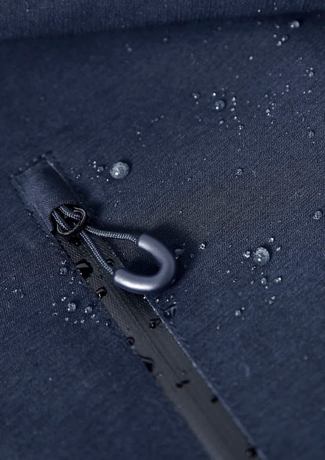 A close-up of a navy rain jacket featuring water droplets and a zipper with a hook detail. The fabric appears water-resistant.