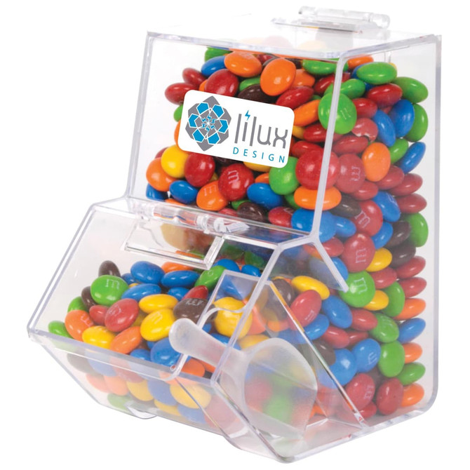 A clear dispenser filled with colourful M&M's, featuring a branding logo on the front.