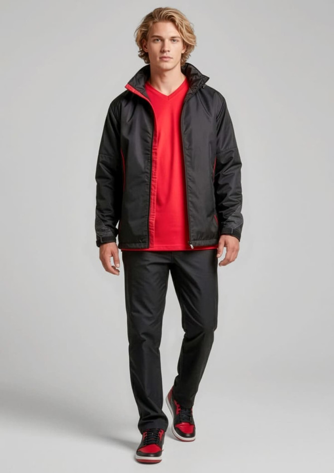 A model wearing unisex black track pants with a red jacket and shirt, featuring a logo on the jacket.