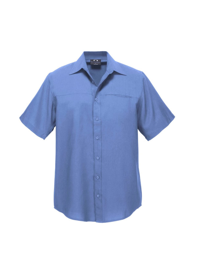 A short sleeve button-up shirt in a light blue colour, featuring a chest pocket and a logo on the neckline.