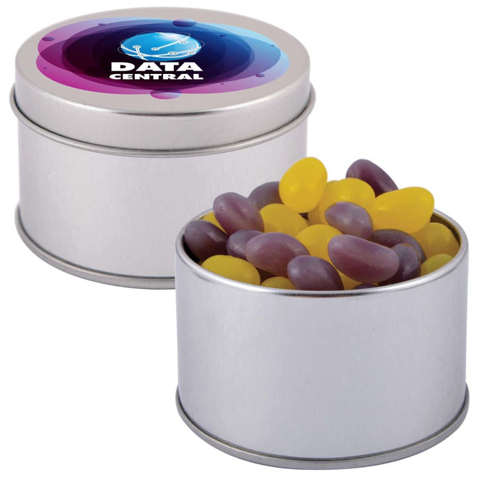 A silver round tin filled with colourful jelly beans in yellow and purple, featuring a branded lid.