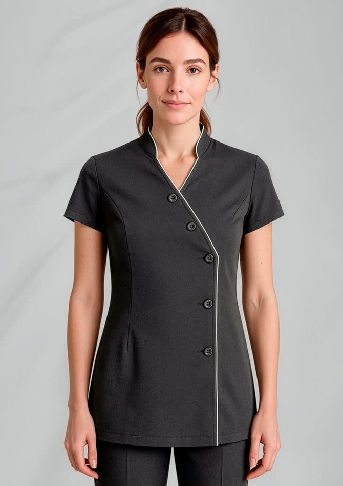 A women's crossover tunic in dark grey with white piping and a round collar, featuring button details.