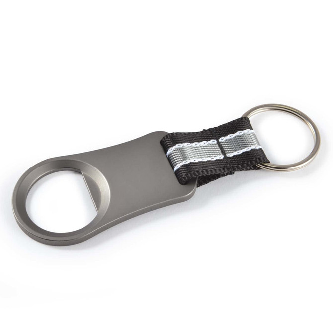 A drink bottle opener in silver, featuring a sturdy black fabric strap and a keyring attachment.