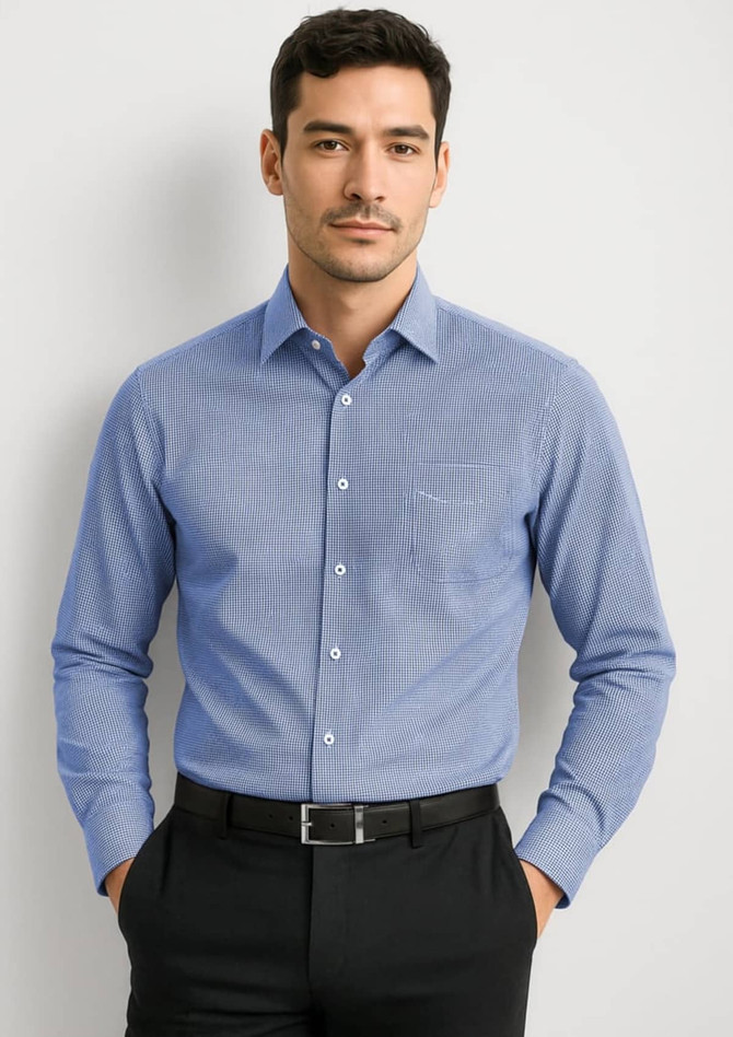 A blue long sleeve button-up shirt with a pocket, featuring a subtle pattern, worn by a man.