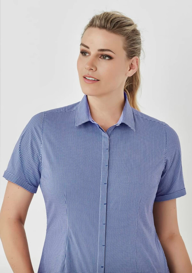 A short-sleeve blue and white checked button-up shirt with a collar and a logo.