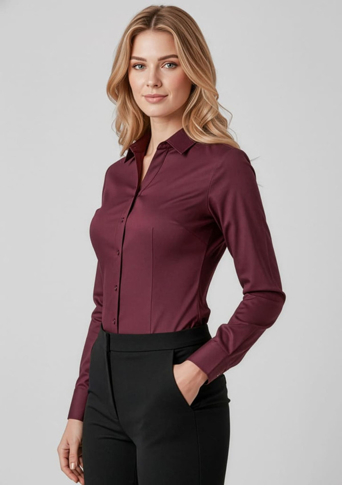 A maroon women's long sleeve button-up shirt, featuring a classic collar and fitted silhouette, paired with black trousers.