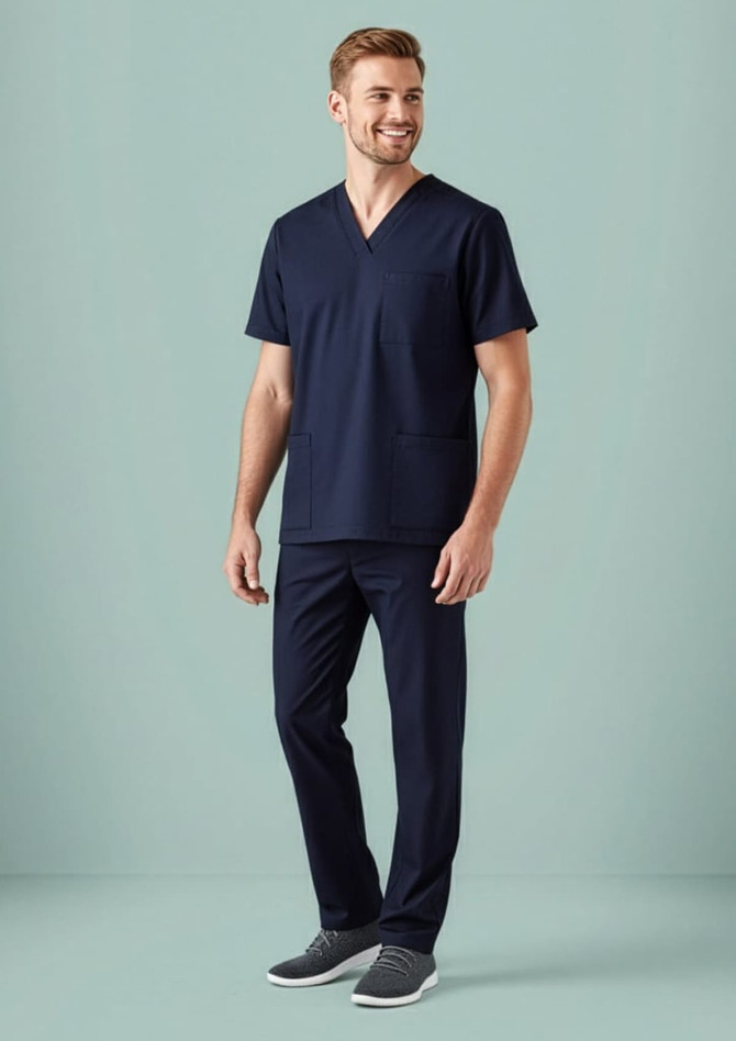 A man is wearing a navy blue scrub top with a V-neck and two pockets, paired with matching scrub trousers.