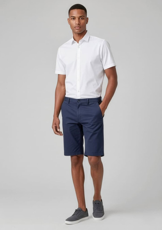 Men's comfort waist cargo shorts in navy blue, paired with a white short-sleeve shirt and grey shoes.
