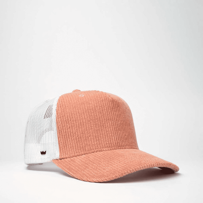 A cord trucker snapback cap in peach with a white mesh back and a logo on the side.