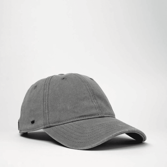 A grey cotton canvas unstructured 6 panel cap with an adjustable strap and a logo.