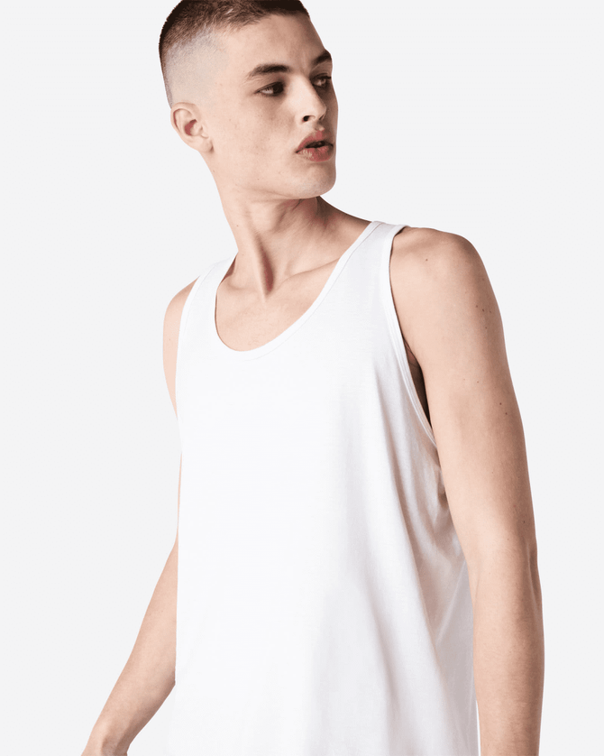 A plain white unisex fine jersey tank top with a relaxed fit. The product features a branding logo.
