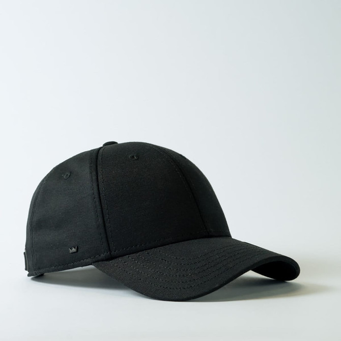 A black 6-panel baseball cap featuring a small logo on the side, set against a light background.