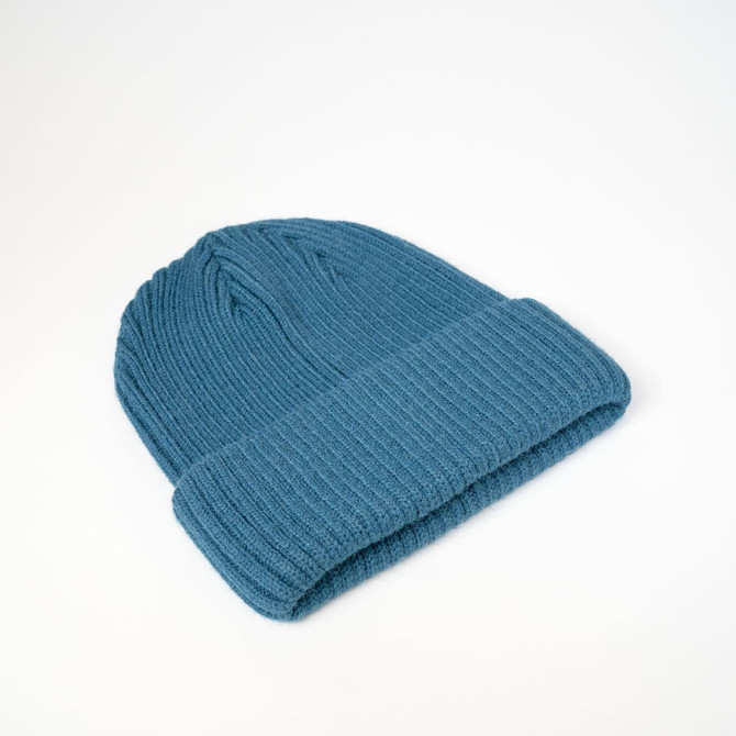 A teal Fisherman's Beanie with a ribbed texture and folded cuff, displayed on a light background.
