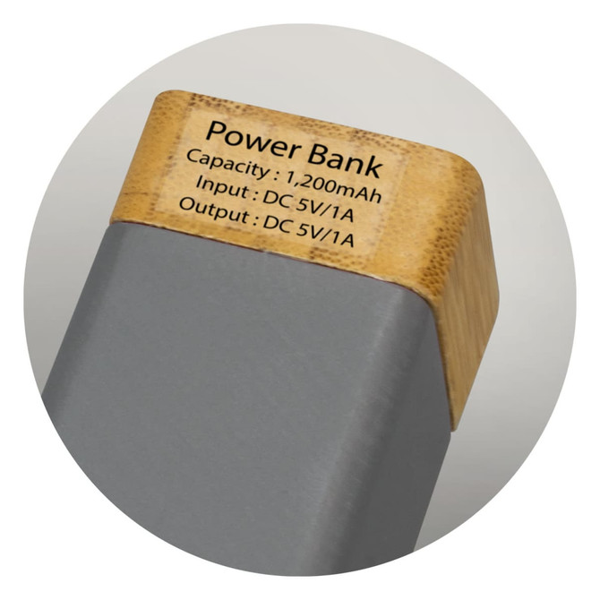 A power bank with a grey body and a natural bamboo top, featuring a logo and specifications on the surface.