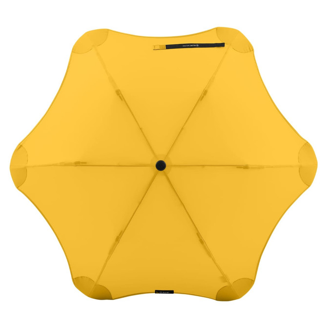A yellow BLUNT Metro Umbrella with a rounded, petal-like design and a central knob. It features a logo on the canopy.
