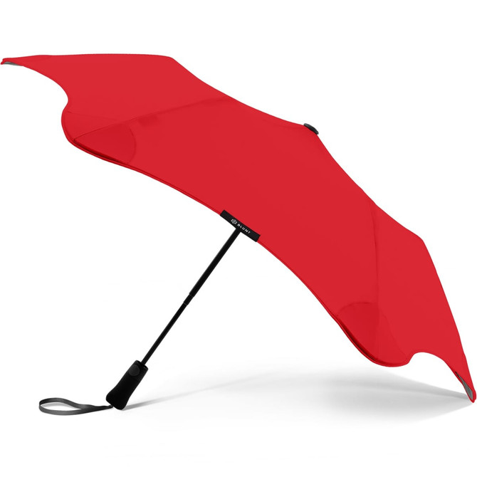 A red BLUNT Metro Umbrella with a sleek design and a black handle, featuring a logo on the canopy.