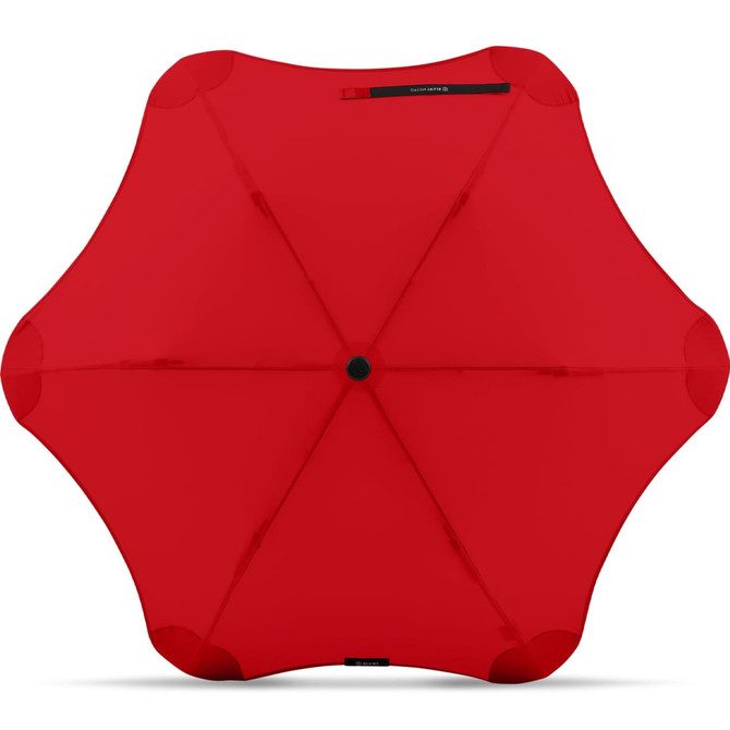 A red BLUNT Metro Umbrella with a unique rounded design and a central button, featuring a logo.