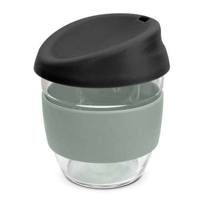 A drink bottle featuring a clear borosilicate design with a black lid and a soft green silicone sleeve.