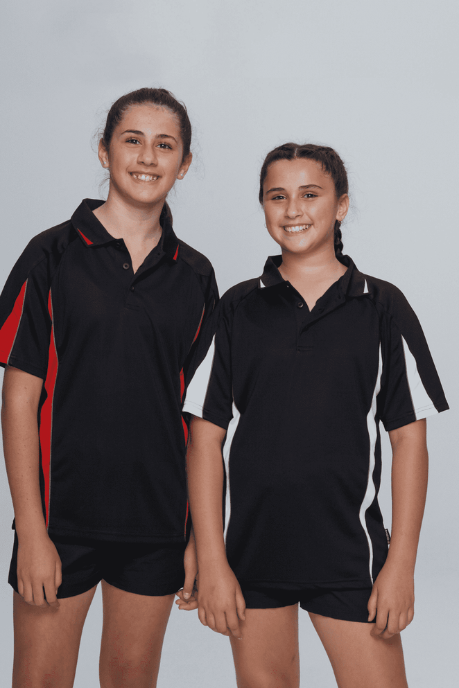 Two girls wearing black polo shirts with red and white details, standing side by side against a grey background.