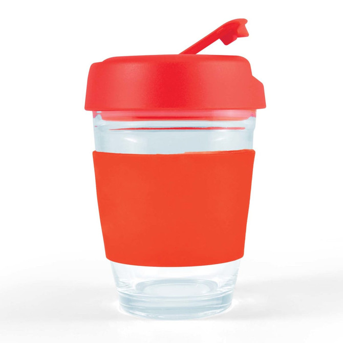 A reusable coffee cup with a clear body and a bright red flip lid and silicone band. It features a logo.
