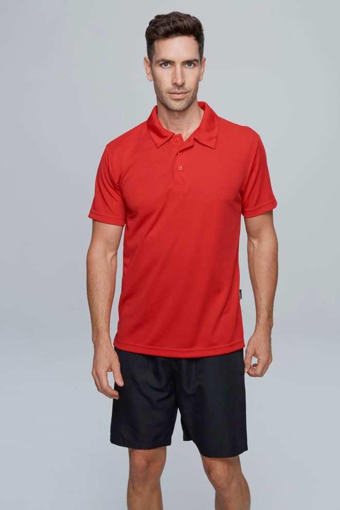 A red polo shirt on a model, paired with black shorts, featuring a small branded logo.