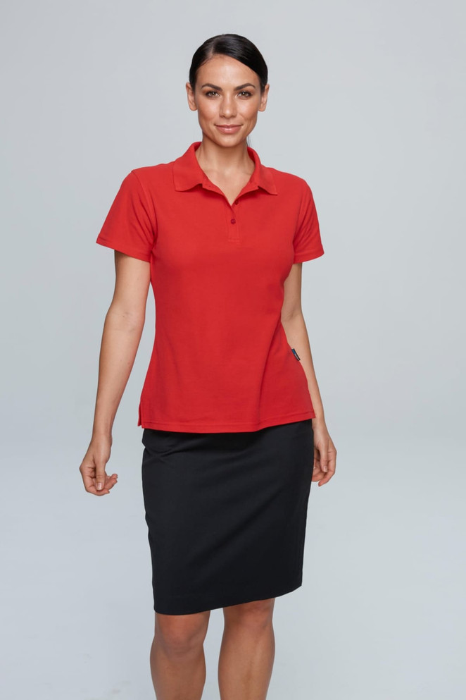 A red polo shirt is displayed, worn by a model paired with a black skirt. The shirt features branding.