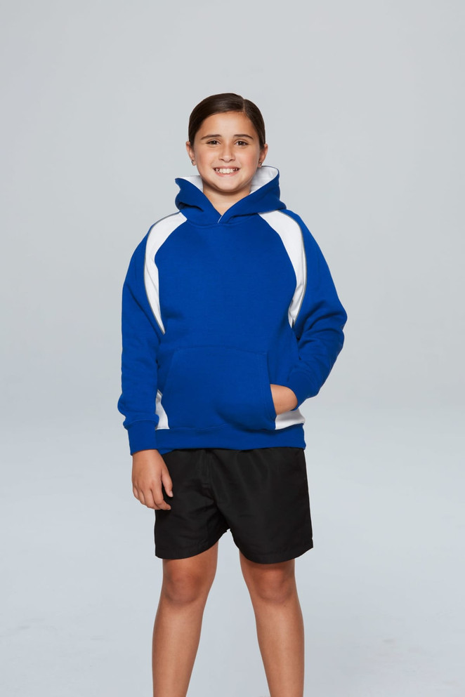 A child stands wearing a blue hoodie with white accents, paired with black shorts, and has a logo on the hoodie.